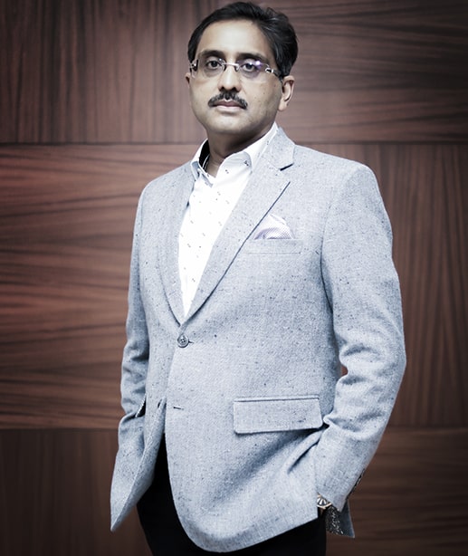 Portrait of Associated Alcohols & Breweries senior executive standing in business suit