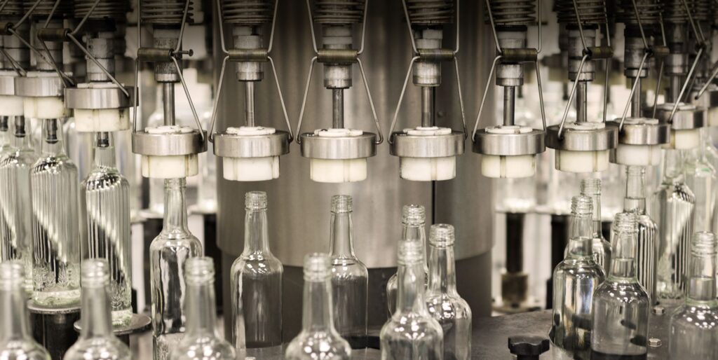 Automated bottling line at Associated Alcohols & Breweries manufacturing plant filling glass spirit bottles
